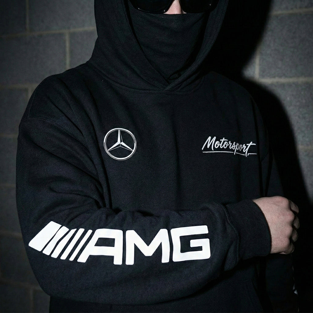 Close up detail of white AMG text printed on the sleeve of a black racing hoodie.