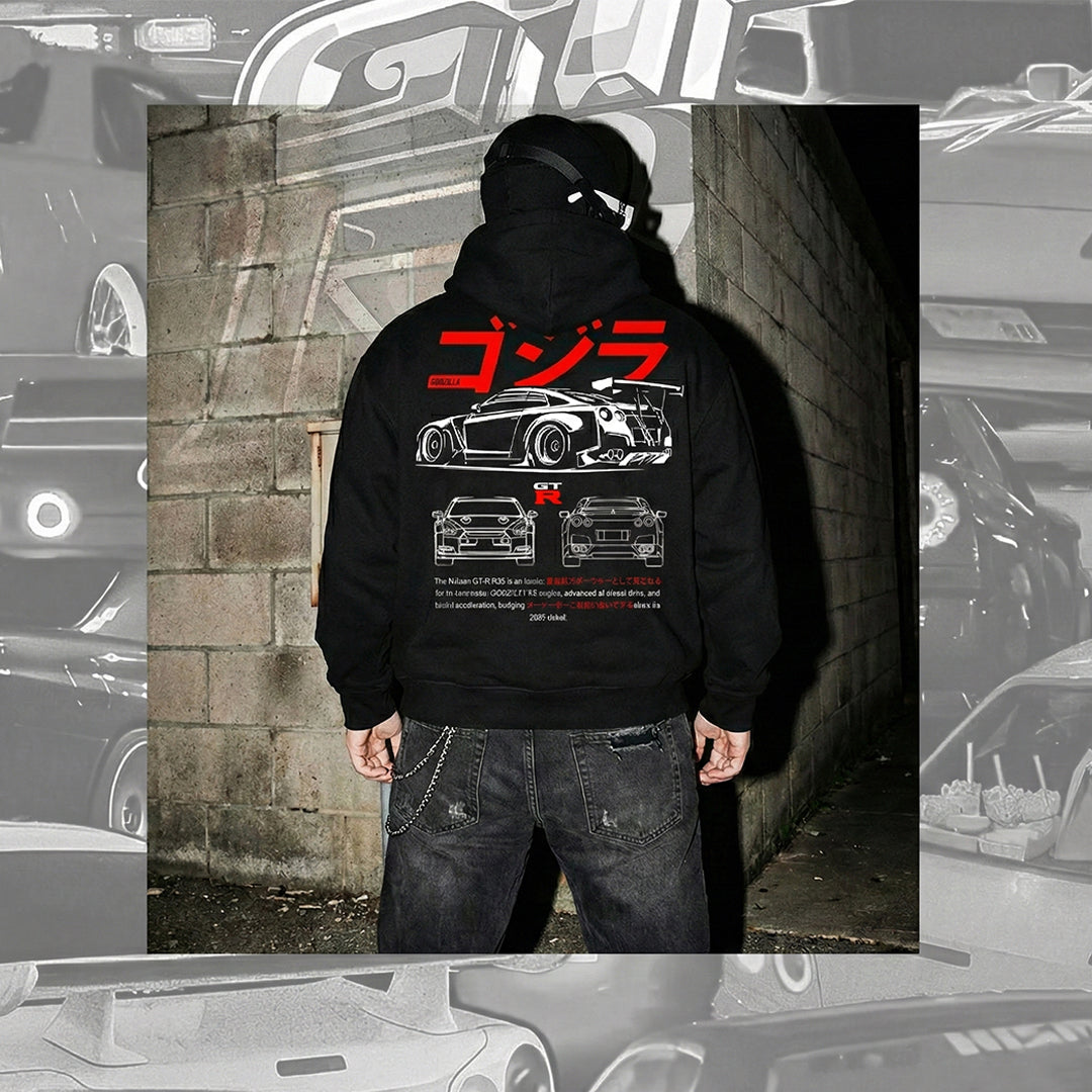 Back view of a model wearing a black hoodie featuring a large graphic of a Nissan GT-R R35. The design includes red Japanese text, white line-art diagrams of the car's front and rear, and technical text specifications.