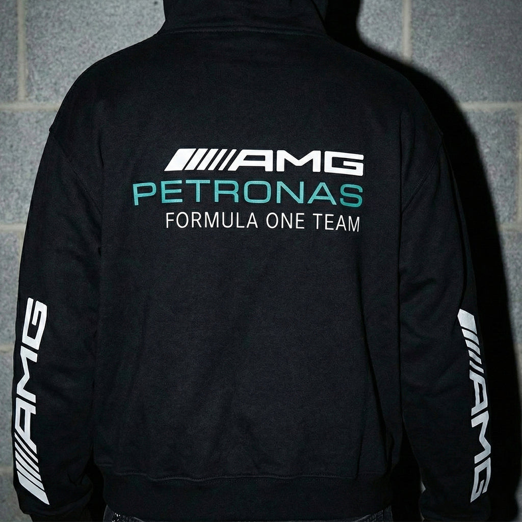 Man wearing Mercedes-AMG Petronas hoodie showing back graphic and sleeve details.