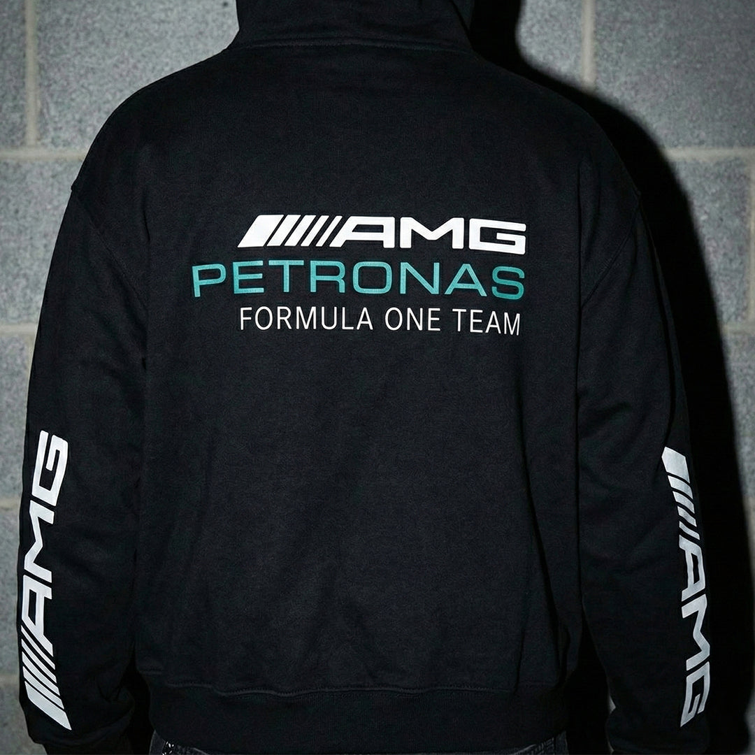Man wearing Mercedes-AMG Petronas hoodie showing back graphic and sleeve details.